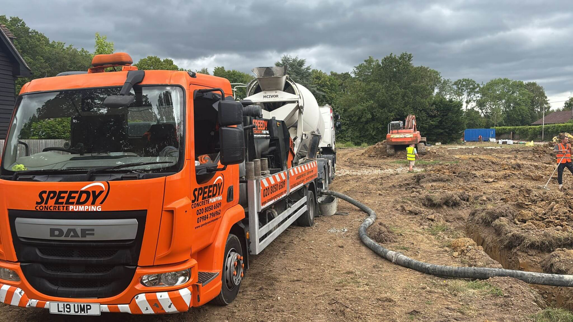 Orange Speedy Concrete Pumping line pump with mixer truck on a construction site